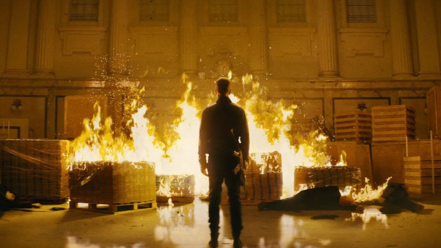 Burn it all down, HUtch standing in front of a structure fire. A Movie still from Nobody