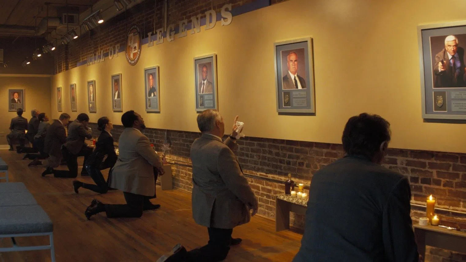 A Movie Still from The Naked Gun 2025 Movie, showcasing the hall of fame and homage to the previous Naked Gun Legends