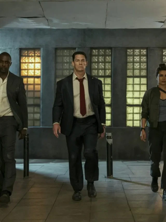 Idris Elba, John Cena, and Priyanka Chopra Jonas walking confidently through a graffiti-covered tunnel in Heads of State.